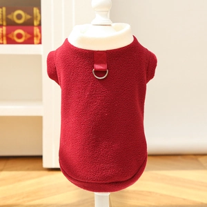 Close-up of red fleece pet vest with white shearling collar and metal D-ring for leash