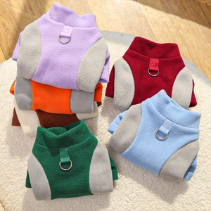 Close-up of colorful fleece pet vests with D-ring harness attachments for small dogs