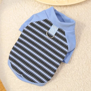 Detail of blue striped dog vest with metal D-ring for leash attachment on soft wool background