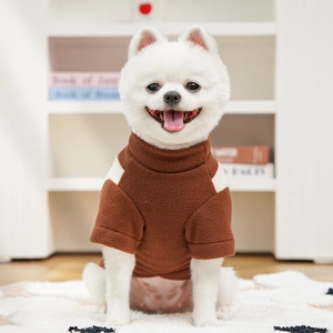 Brown fleece pet sweater with white shoulder panels shown in a cozy home setting