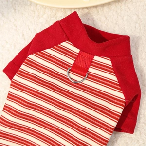 Detail of pet shirt with red striped fabric, cotton texture, and metal D-ring for leash