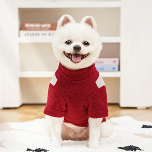 Detail of red fleece pet sweater with high neck and gray shoulder patchwork on a Pomeranian