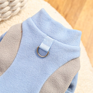 Close-up of blue fleece pet vest with durable metal D-ring for leash attachment