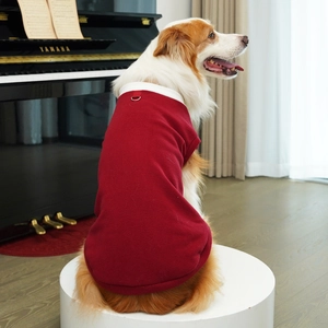 Detail of red fleece dog vest with white stand collar and D-ring for leash attachment