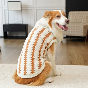Detail of plush orange wavy dog vest with warm fleece lining and sturdy metal D-ring