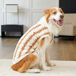 Detail of soft orange and white wavy fleece fabric on a warm winter pet sweater