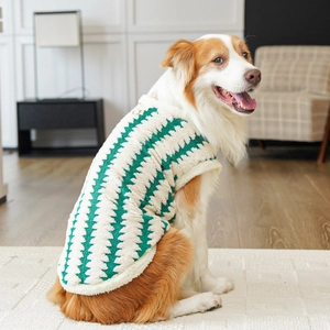 Detail of warm plush dog vest with green zigzag stripes and metal D-ring for leash attachment