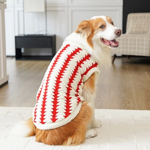 Close-up of thick red and white zigzag patterned plush dog vest with hemmed edges