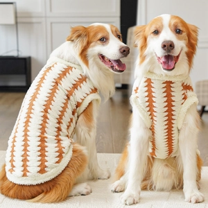 Close-up of plush knit dog vest with orange and cream geometric pattern for large dogs