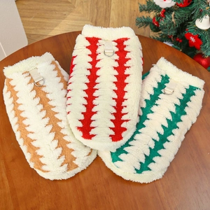 Detail of plush pet vests in red, green, and brown with metal D-rings for leashes