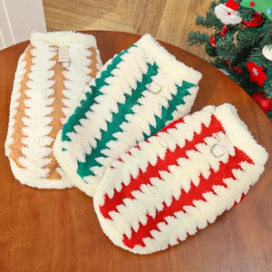 Three warm fleece dog vests in brown, green, and red with festive Christmas decor