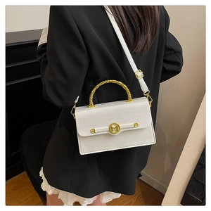 Detailed view of white PU leather box bag with gold spiral handle and M-letter clasp
