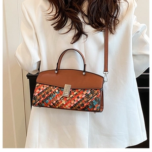 Detail showing colorful woven pattern and silver twist lock on the brown leather bag