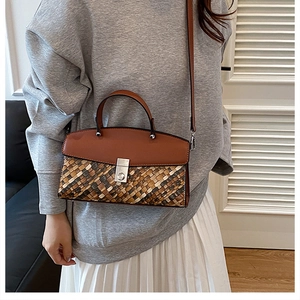 Detail of the woven texture and premium leather on the brown crossbody handbag