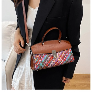 Detail of colorful woven texture and brown leather flap on a stylish crossbody Kelly bag