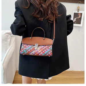 Detailed back view of a woven leather handbag styled in a modern home interior
