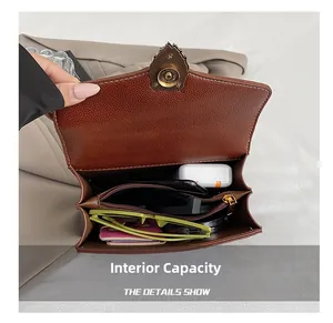 Macro view of the spacious triple-compartment interior for brown pebbled leather bag