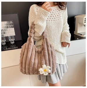 Detail of coffee brown plush tote bag with ribbed texture and white knit flower charm