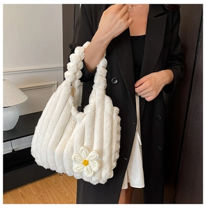 Close-up of white plush tote bag showing vertical striped texture and crochet flower
