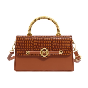 Brown faux crocodile leather handbag with gold M buckle and metal top handle