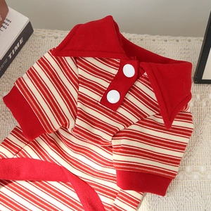 Detail view of red and white striped polo pet shirt with large collar and white buttons