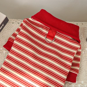 Close-up of red and white striped pet shirt with integrated metal D-ring for leash attachment