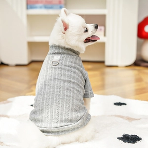 Detail of grey cable-knit dog sweater with metal D-ring for leash attachment