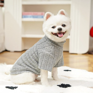 Detail of grey cable knit pet sweater with high neck and thick elastic texture on a dog
