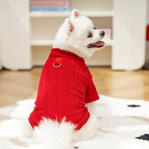 Detail of red cable-knit pet sweater with a metal D-ring for leash attachment