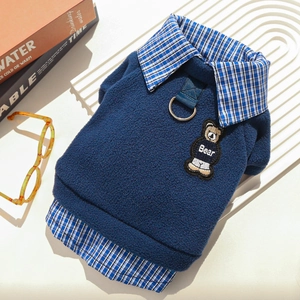 Detail of navy fleece dog hoodie with bear embroidery and metal D-ring for leash attachment
