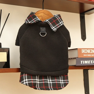 Close-up of pet fleece vest featuring plaid collar and metal D-ring for leash attachment