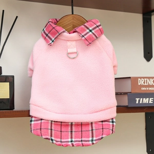 Close-up of pink fleece pet vest with plaid collar and metal D-ring for leash attachment