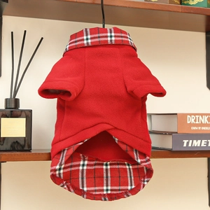 Detail of red fleece pet coat with British style plaid collar and warm texture