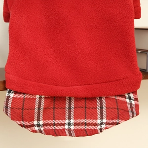 Detail of red fleece cat vest showing plaid fabric hem and high-quality stitching