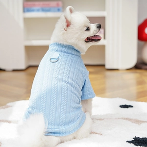 Close-up of blue pet t-shirt with herringbone knit texture and metal D-ring on a Pomeranian
