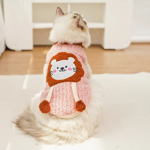 Detailed view of pink fleece pet vest featuring a cute lion pattern and soft pom-poms
