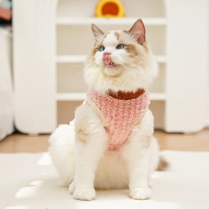 Close-up of pink fleece pet vest showing soft lamb wool texture and brown knit collar