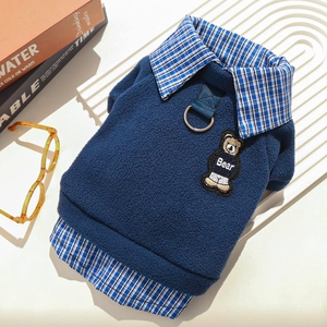 Close-up of blue fleece pet sweater with faux layering and bear patch detail