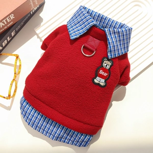 Detail of red fleece pet sweater with blue plaid collar and silver D-ring leash attachment