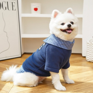 Detail of navy blue pet fleece sweater with blue plaid collar and badge embroidery
