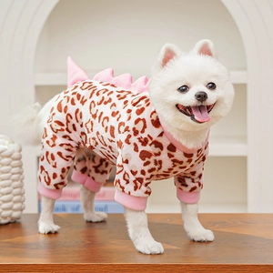 Macro shot of pink leopard dog onesie with dinosaur spikes and soft plush fabric