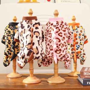 Detail of dinosaur-style pet jumpsuits with leopard prints and metal D-rings on racks