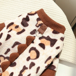 Detail of leopard print pet fleece with metal D-ring leash attachment and dinosaur spine spikes