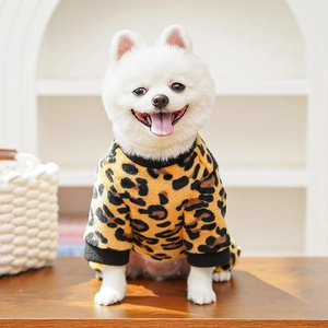 Close-up of fluffy leopard print pet hoodie with black ribbed cuffs on a white Pomeranian