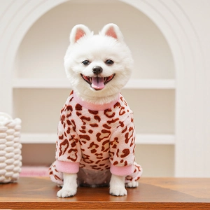 Close-up of soft pink leopard print fleece pet pajamas on a white Pomeranian dog