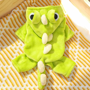 Detail of bright green dinosaur pet onesie with soft plush fabric and decorative scales