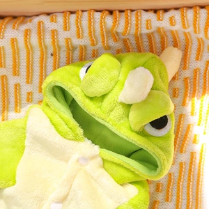 Detail of plush dinosaur cat onesie showing soft fleece texture and snap buttons