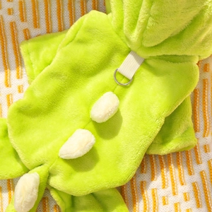 Detail of green fleece pet dinosaur onesie with soft fabric texture and metal D-ring