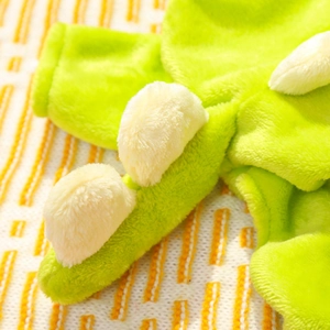 Close-up of soft green flannel pet dinosaur costume featuring plush white back spikes