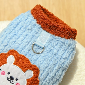 Close-up of warm blue fleece pet vest with metal D-ring and lion patch detail